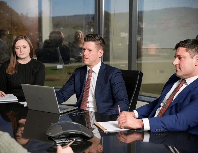 Three professionals in a business meeting.