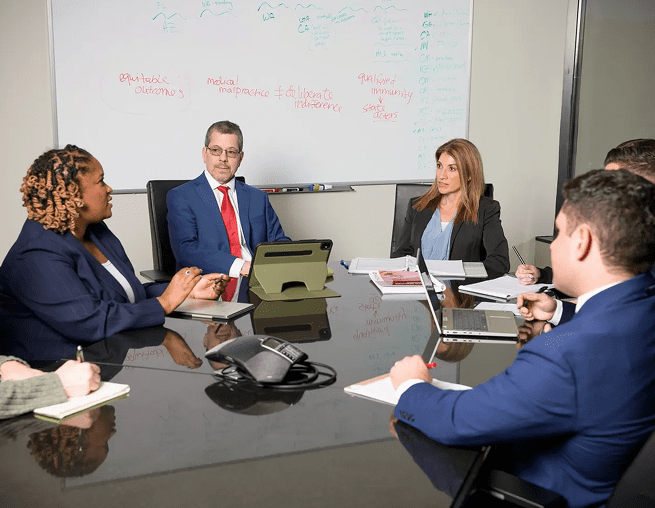 Business meeting with diverse professionals at table.