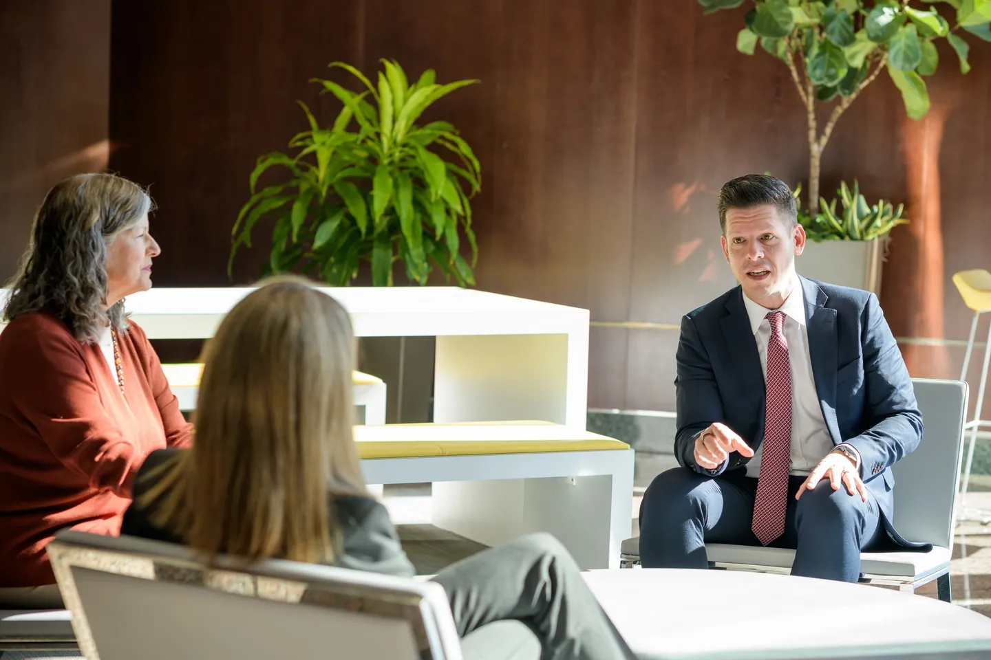 Two professionals engaged in a business discussion in a modern office.