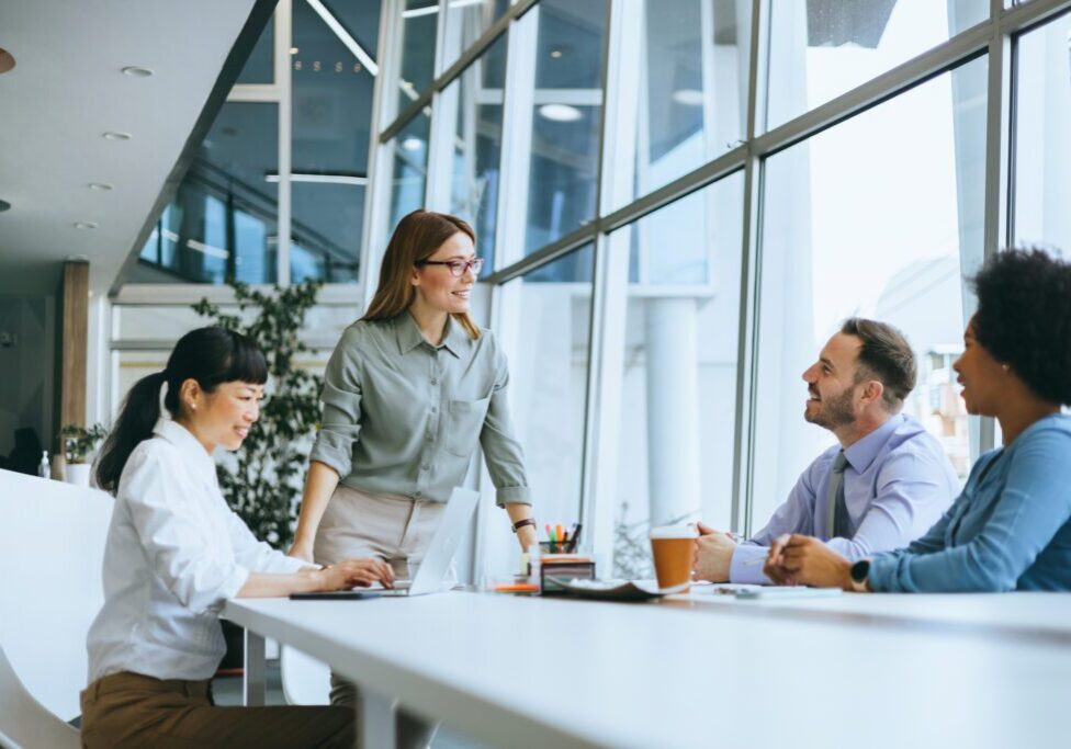 Team meeting in modern office with windows.