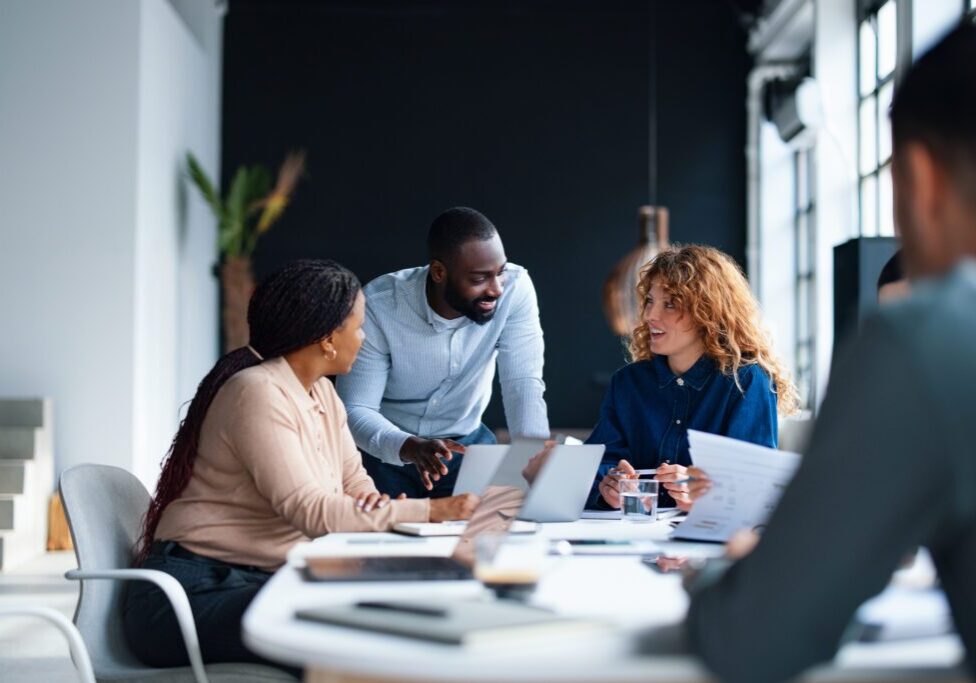 Office team collaborating around a table.